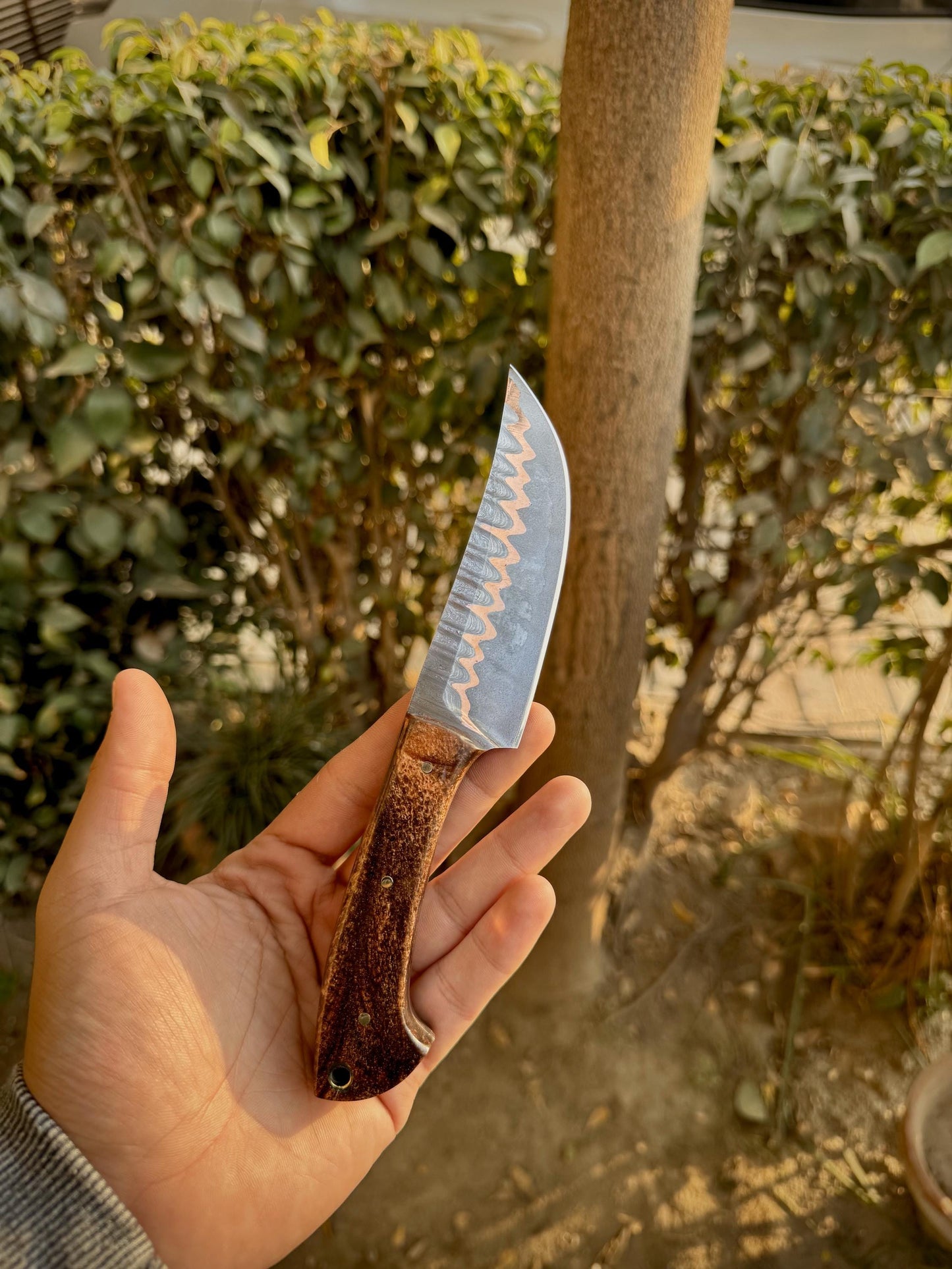 Ergonomic copper-infused resin handle with polished finish and full tang construction